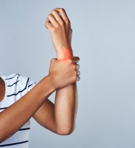 woman holding wrist in pain